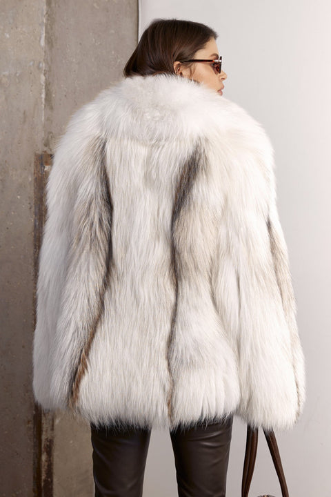 A woman wearing a high-end oversized white fox fur coat, crafted for both comfort and sophistication, with radiant natural tones and a flowing fit.